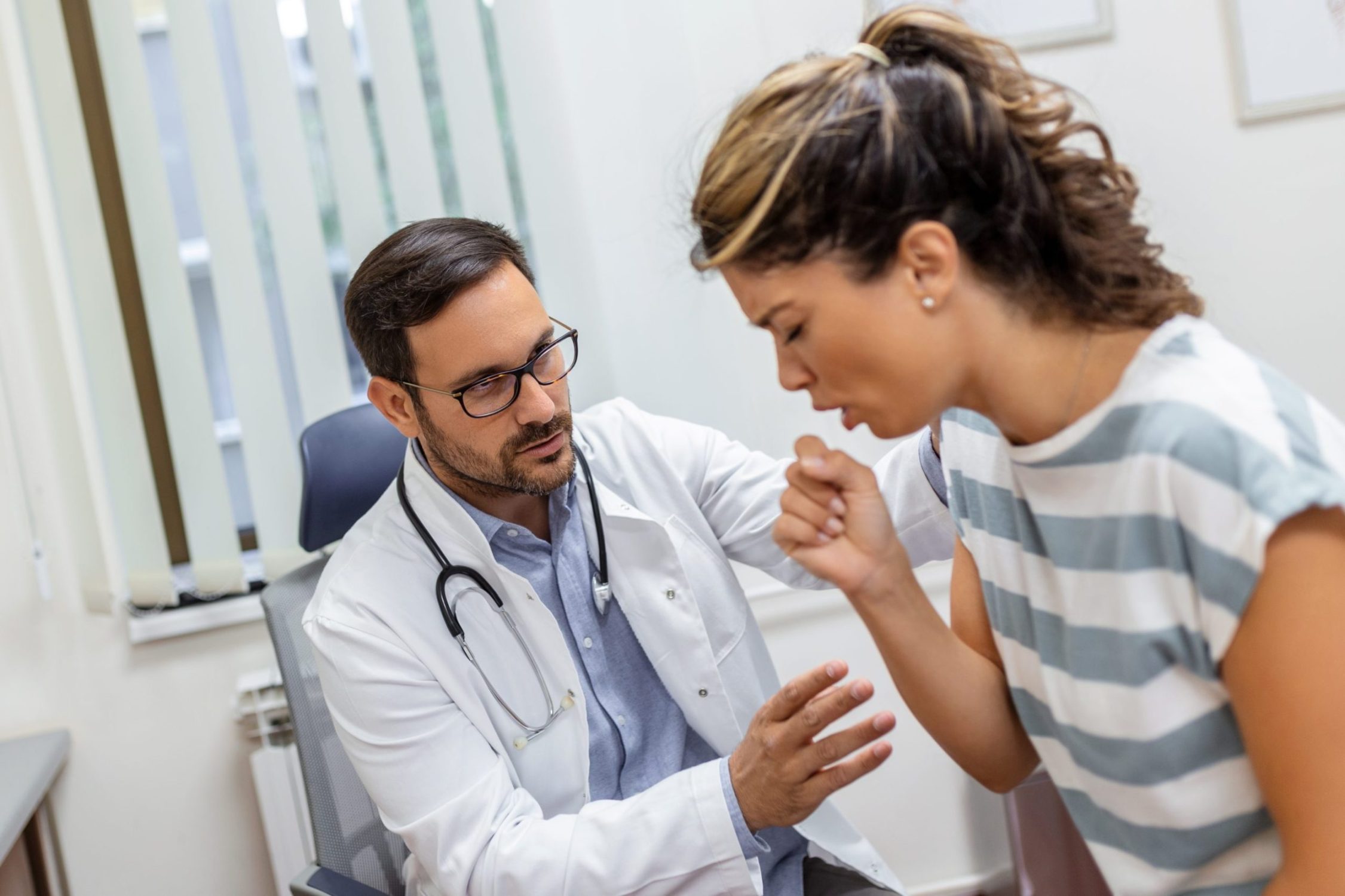 Healthcare professional using stethoscope to assess patient with chronic cough