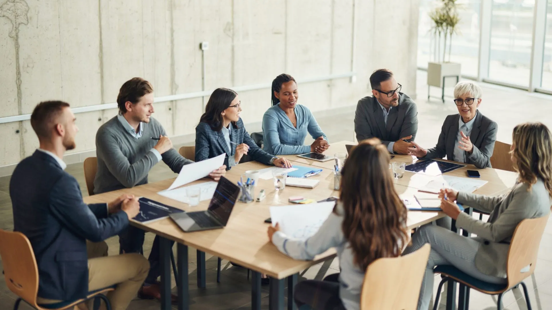 Professional diverse leadership team in a modern boardroom discussing assessment results